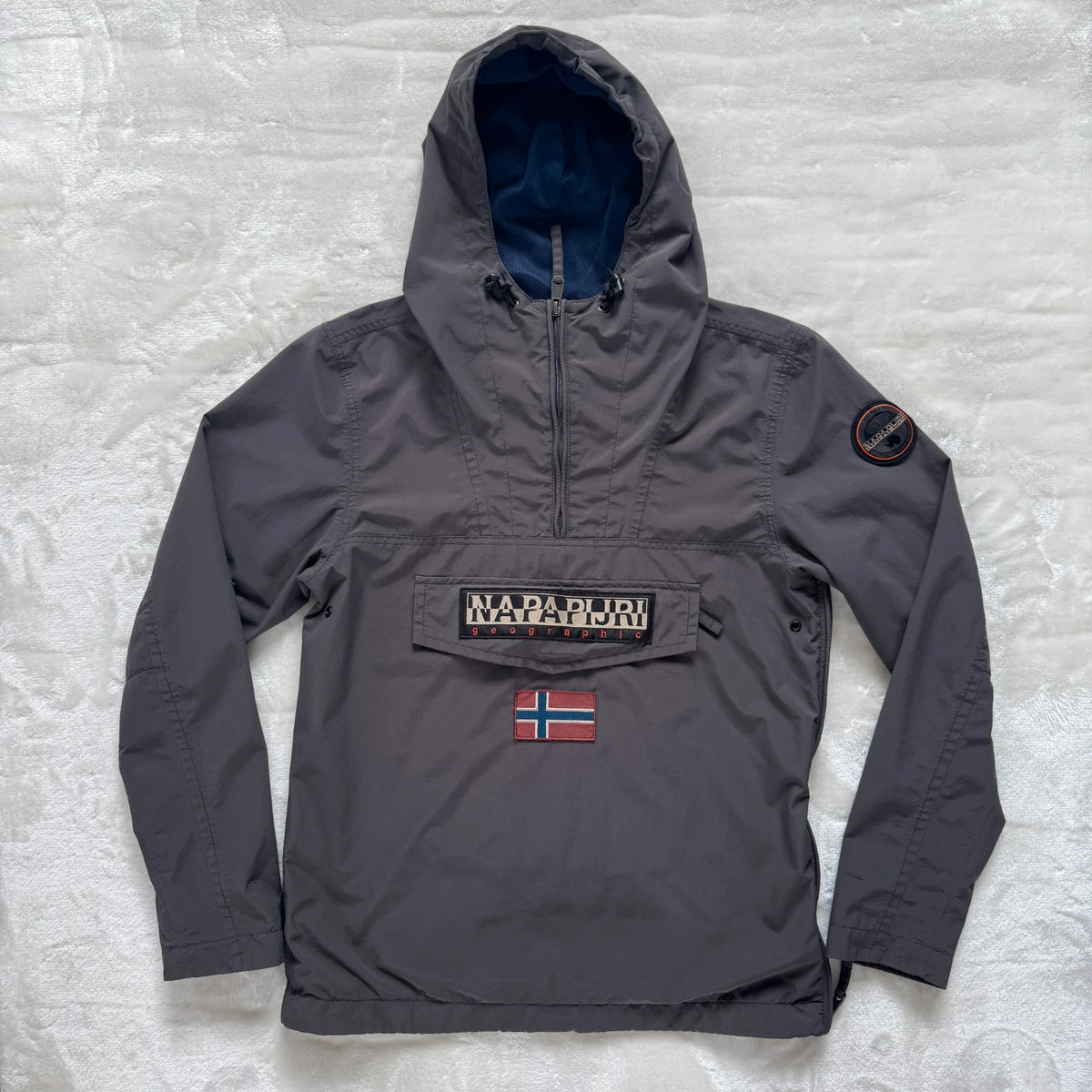 Napapijri grey pullover jacket with logo patch and ventilation zips, lightweight anorak design.