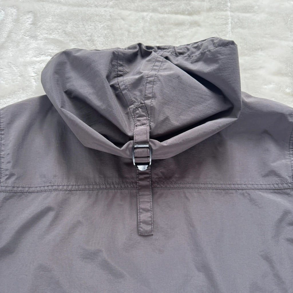 Napapijri grey pullover jacket with logo patch and ventilation zips, lightweight anorak design.