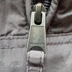 Napapijri grey pullover jacket with logo patch and ventilation zips, lightweight anorak design.