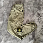Stone Island khaki cuffed cargo trousers with logo patch and multiple pockets.