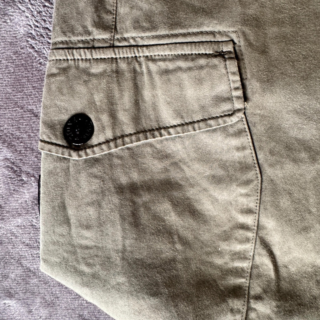 Stone Island khaki cuffed cargo trousers with logo patch and multiple pockets.