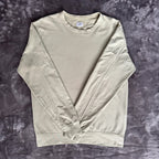 C.P. Company green sweatshirt with ribbed hem and signature goggle lens detail.