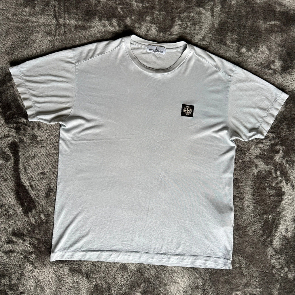 Stone Island light blue t-shirt with logo patch and crew neck design.