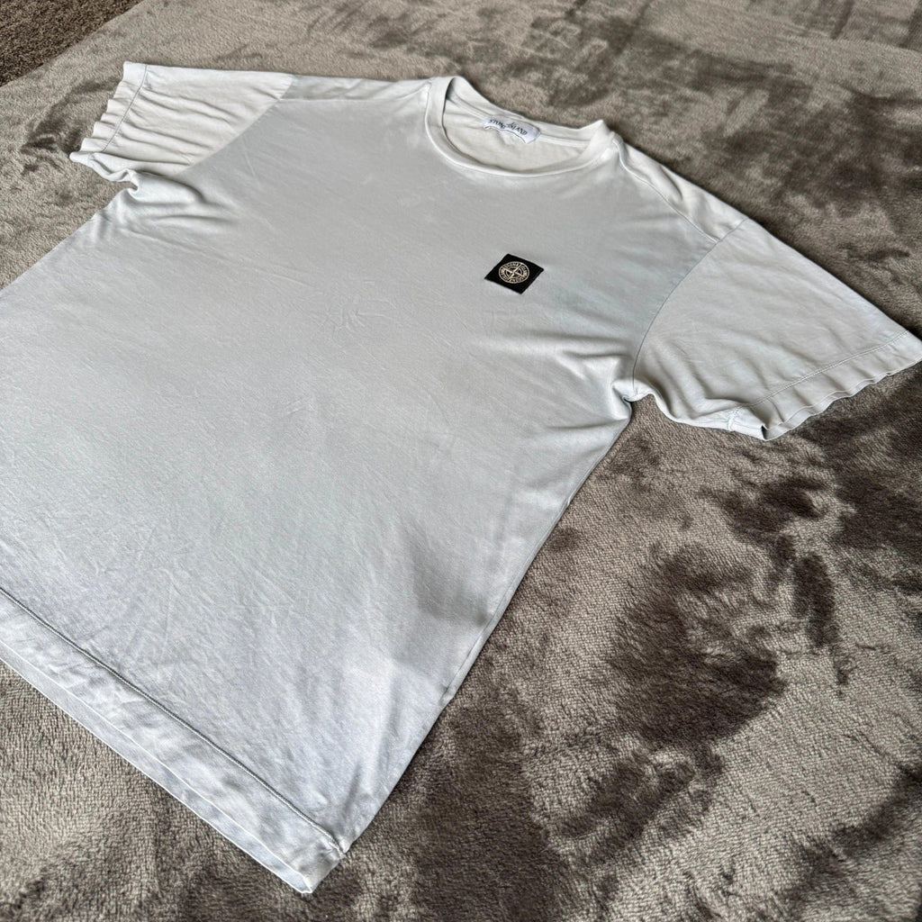 Stone Island light blue t-shirt with logo patch and crew neck design.