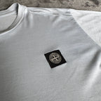 Stone Island light blue t-shirt with logo patch and crew neck design.
