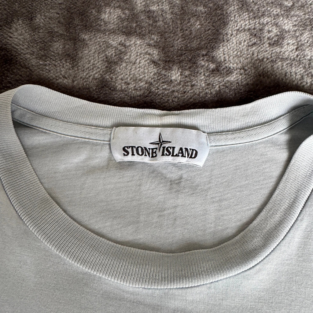 Stone Island light blue t-shirt with logo patch and crew neck design.