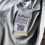 Stone Island light blue t-shirt with logo patch and crew neck design.