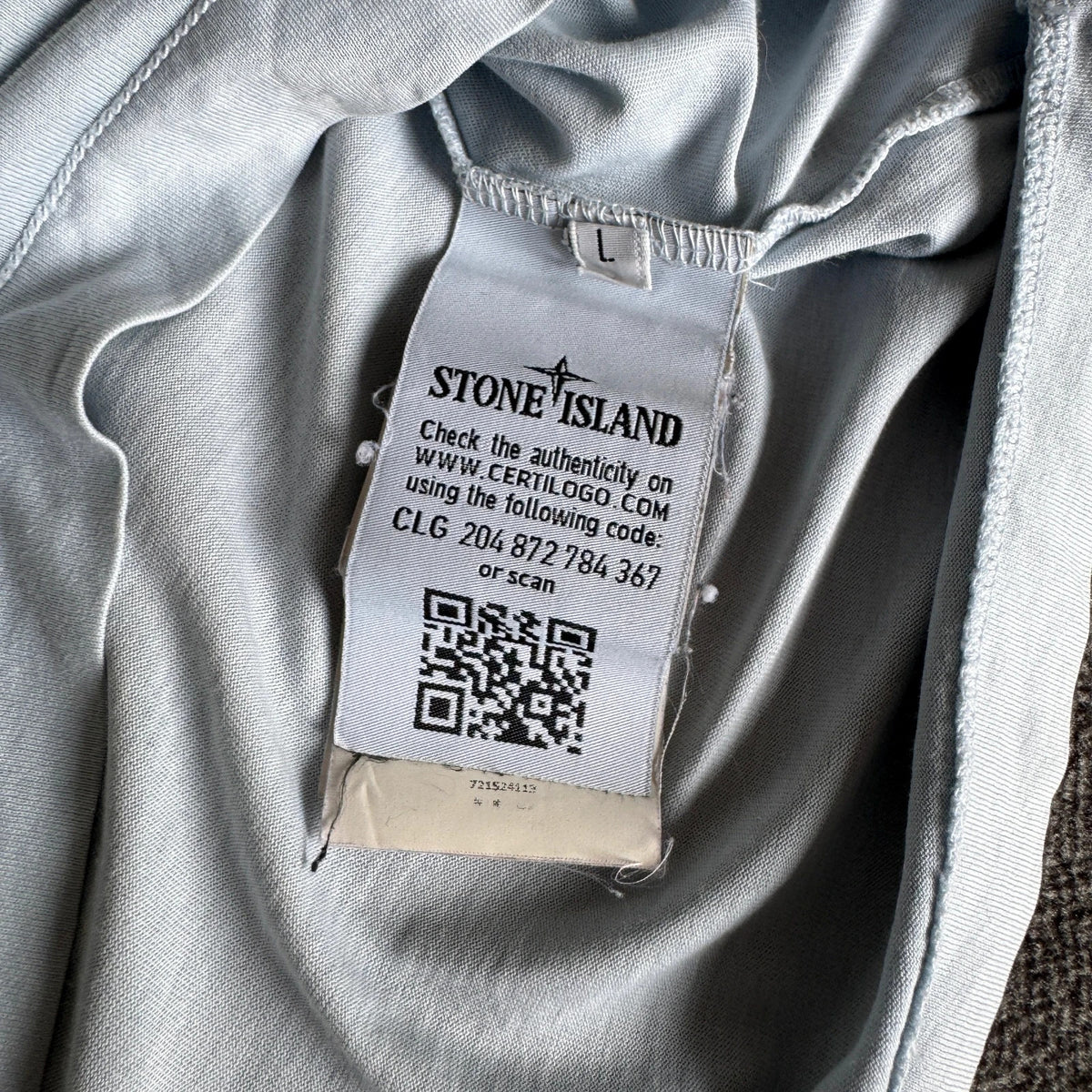 Stone Island light blue t-shirt with logo patch and crew neck design.