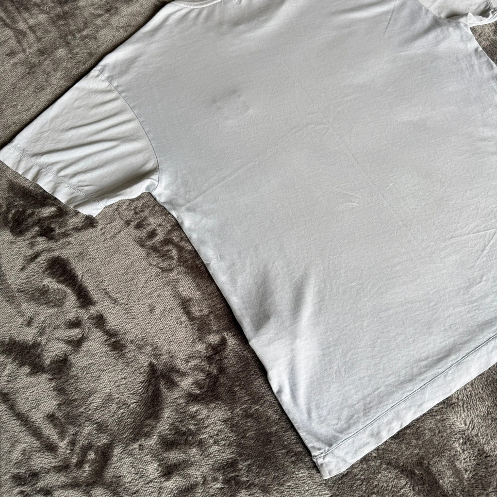 Stone Island light blue t-shirt with logo patch and crew neck design.