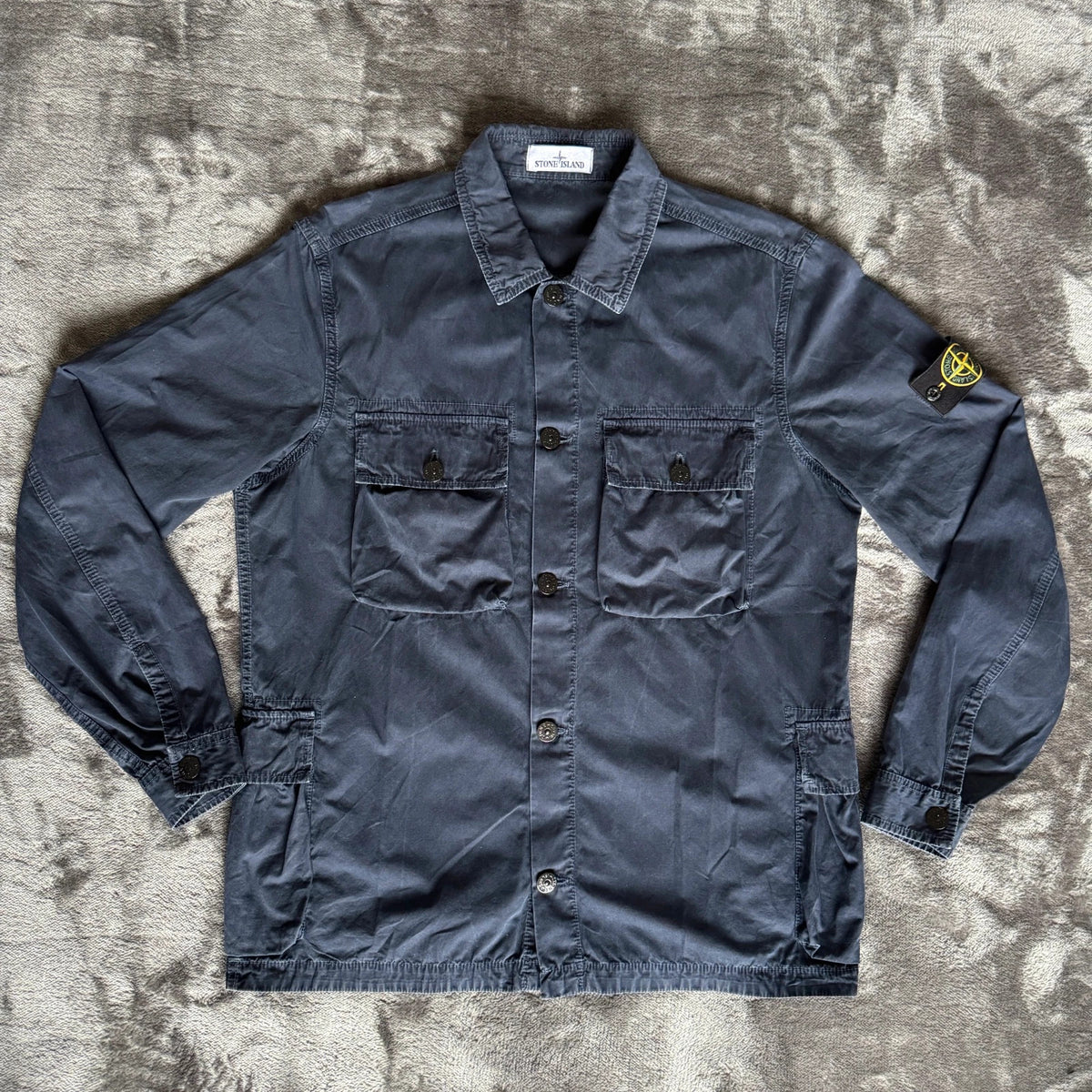Stone Island navy overshirt with multi pockets and iconic compass logo.
