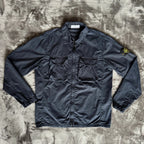 Stone Island navy overshirt featuring iconic compass logo and durable fabric.