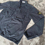 Stone Island navy overshirt featuring iconic compass logo and durable fabric.