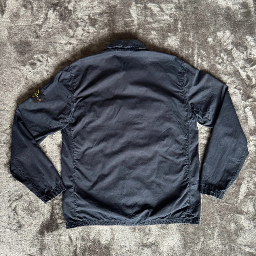 Stone Island navy overshirt featuring iconic compass logo and durable fabric.