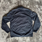 Stone Island navy overshirt featuring iconic compass logo and durable fabric.