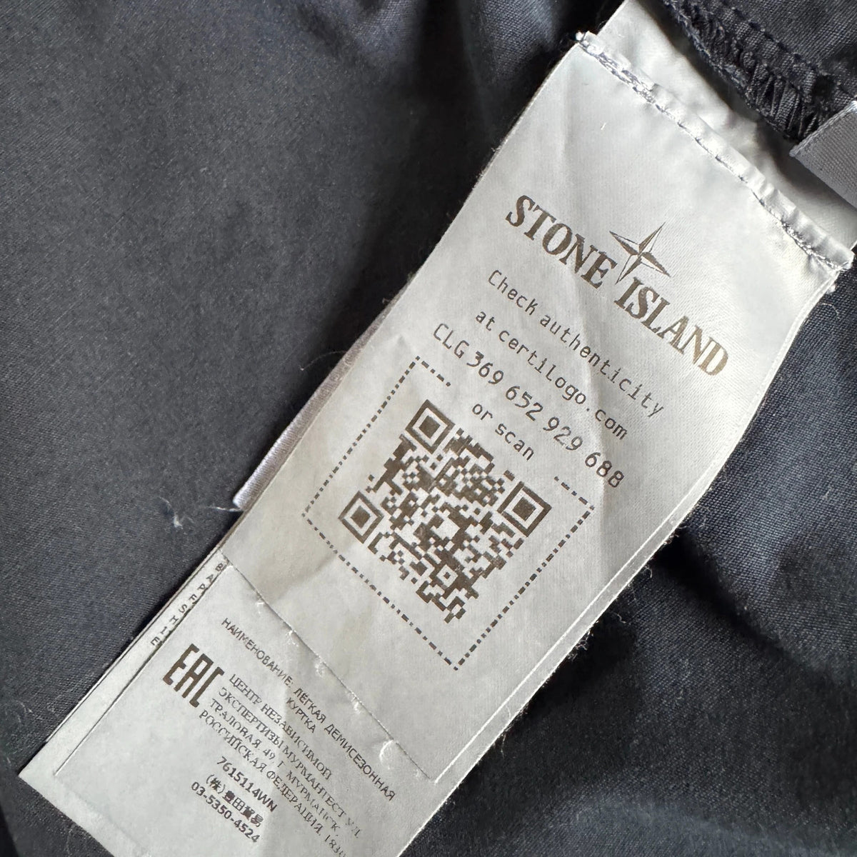 Stone Island navy overshirt featuring iconic compass logo and durable fabric.