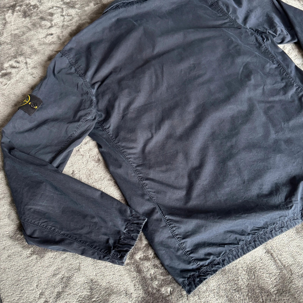 Stone Island navy overshirt featuring iconic compass logo and durable fabric.