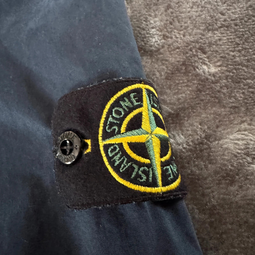 Stone Island navy overshirt featuring iconic compass logo and durable fabric.