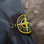 Stone Island navy overshirt featuring iconic compass logo and durable fabric.