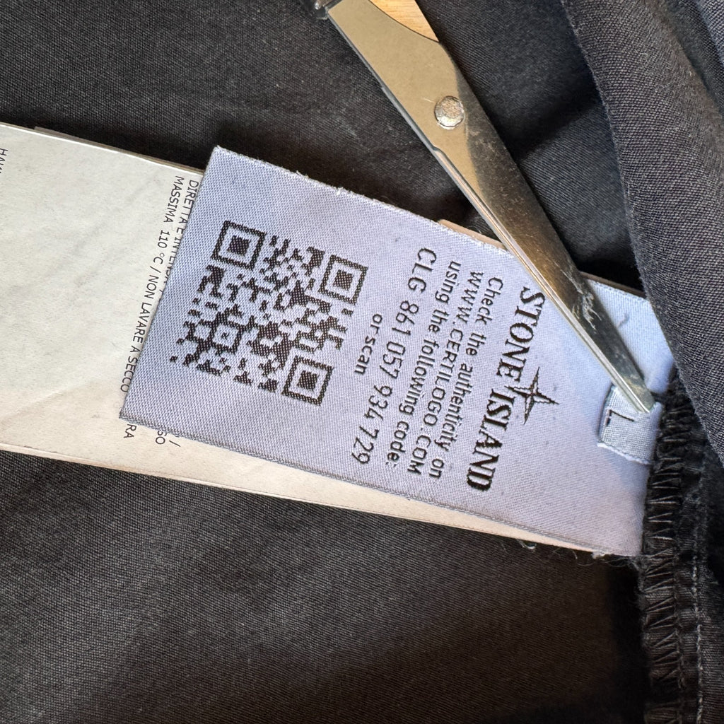 Stone Island black overshirt with logo patch and button-up front detail.