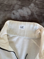 C.P. Company white quarter zip sweatshirt with logo patch and soft cotton material.