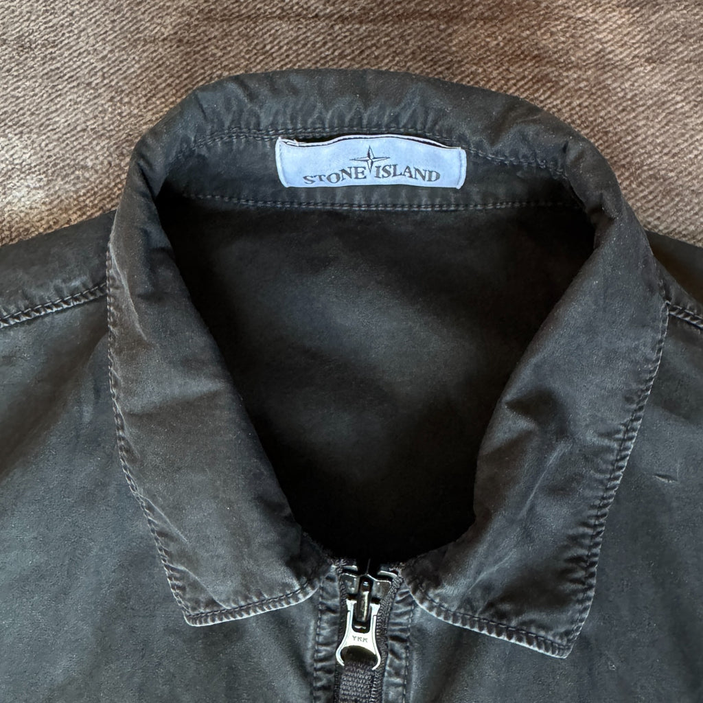 Stone Island black overshirt with logo patch and button-up front detail.