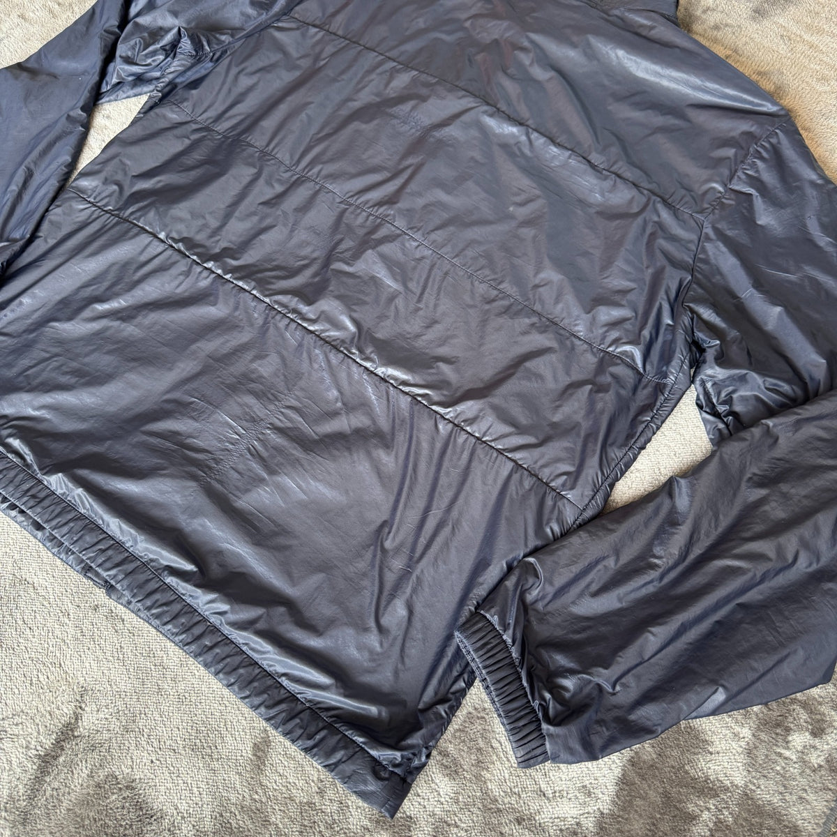 Stone Island navy quilted jacket with logo patch and micro rip stop material.