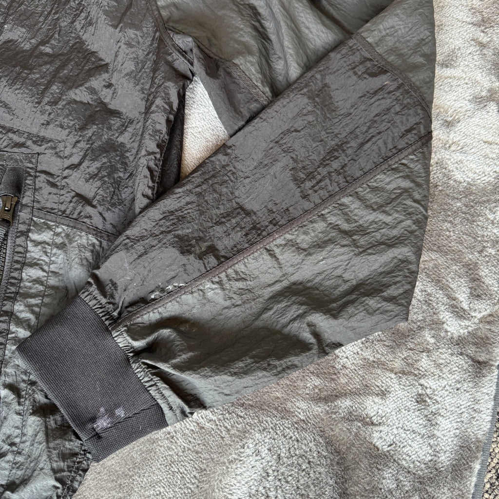 Stone Island black nylon metal Watro jacket with logo badge and visible wear marks.