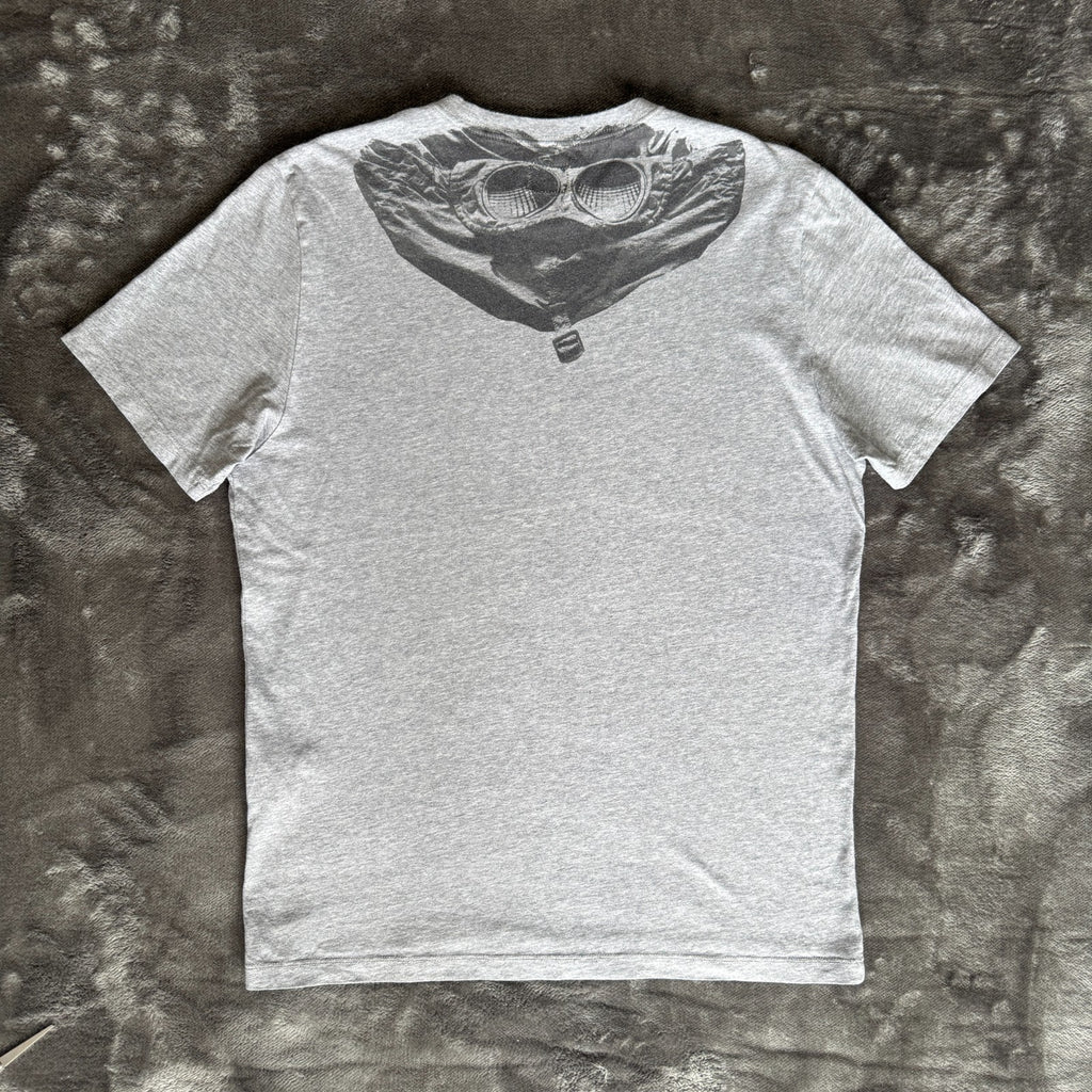 C.P. Company grey t-shirt featuring distinctive goggle print and logo detail.