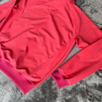Stone Island fuchsia track jacket with logo badge and stretch nylon material.
