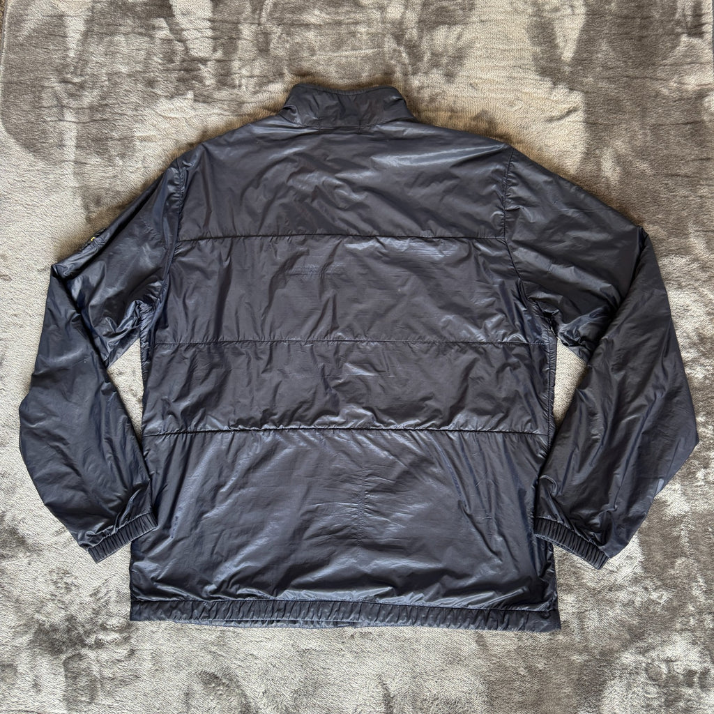 Stone Island navy quilted jacket with logo patch and micro rip stop material.