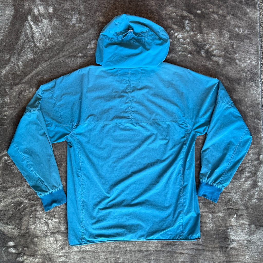 C.P. Company blue hooded smock with logo patch and Pro-Tek material details.