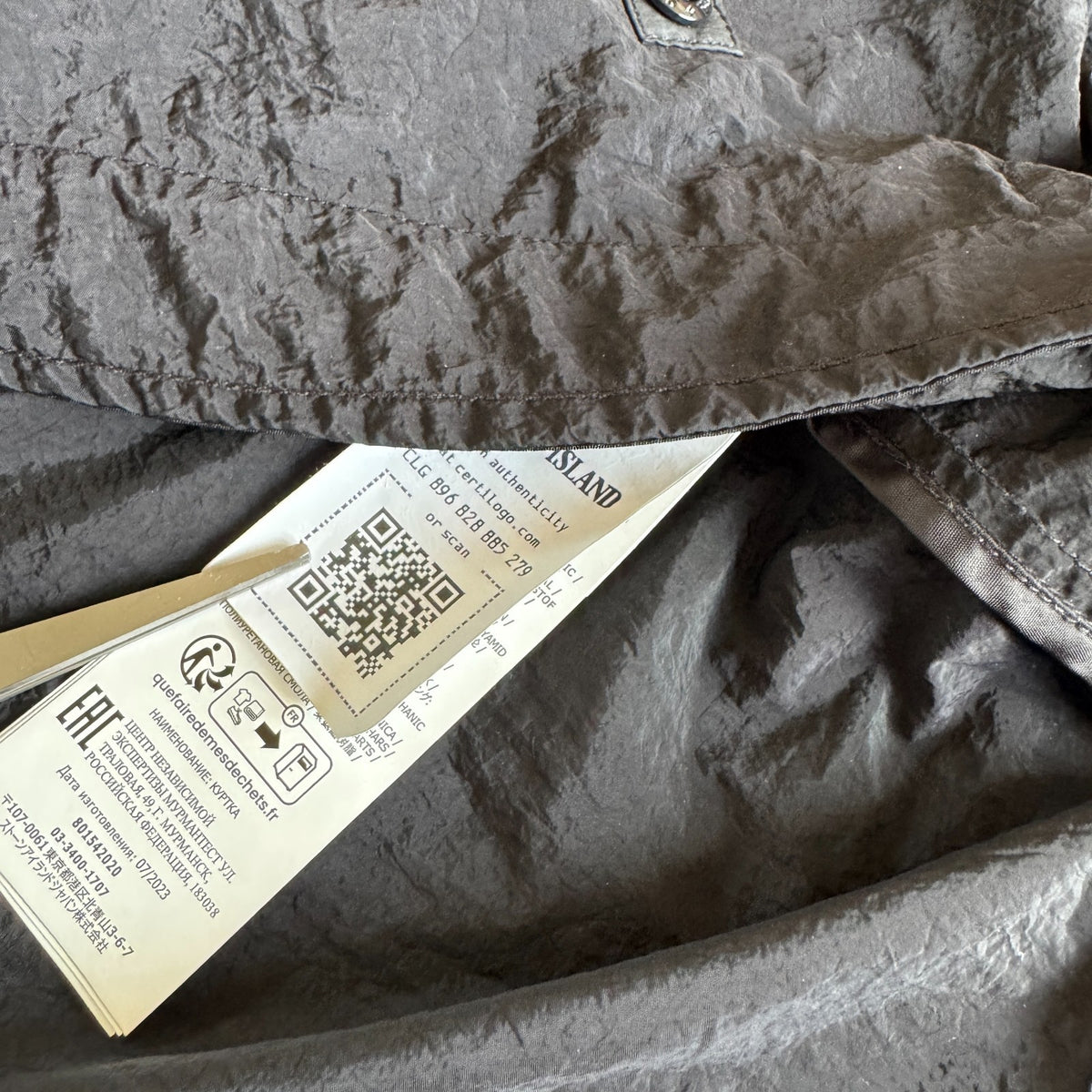 Stone Island black nylon metal Watro jacket with logo badge and visible wear marks.
