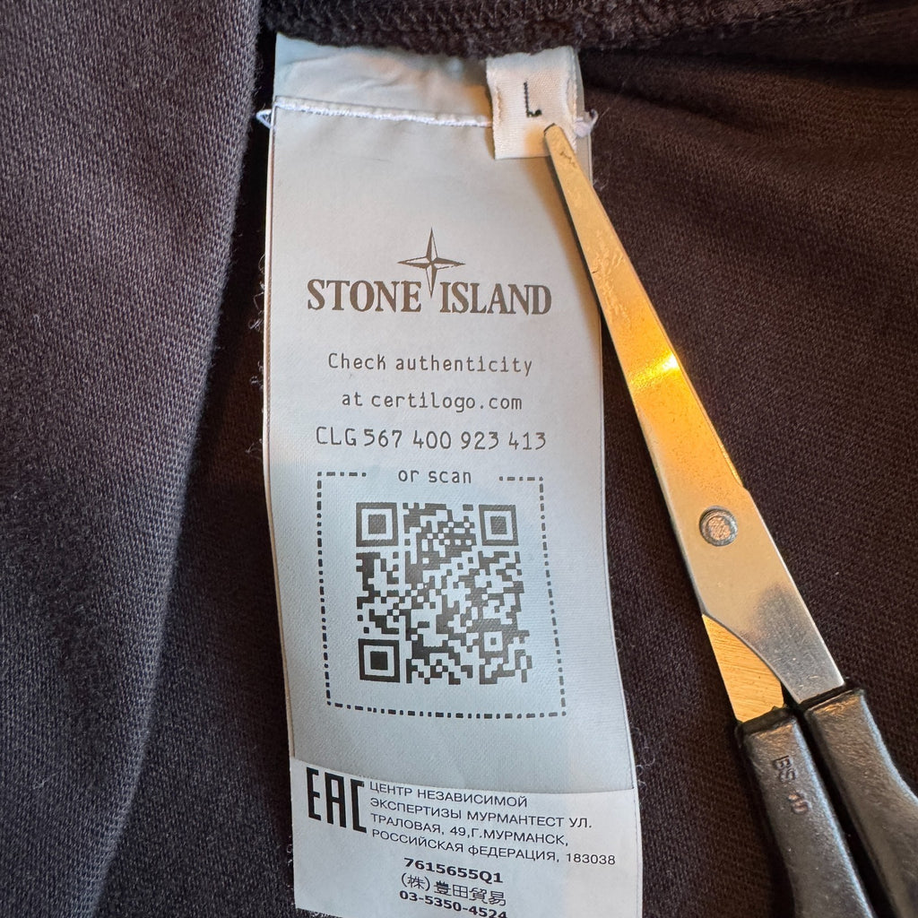 Stone Island black crewneck sweatshirt with 40th anniversary badge and logo patch.