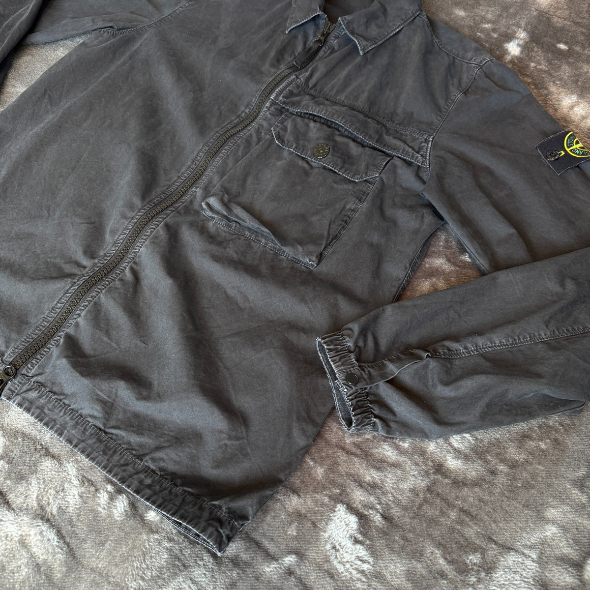 Stone Island black overshirt with logo patch and button-up front detail.