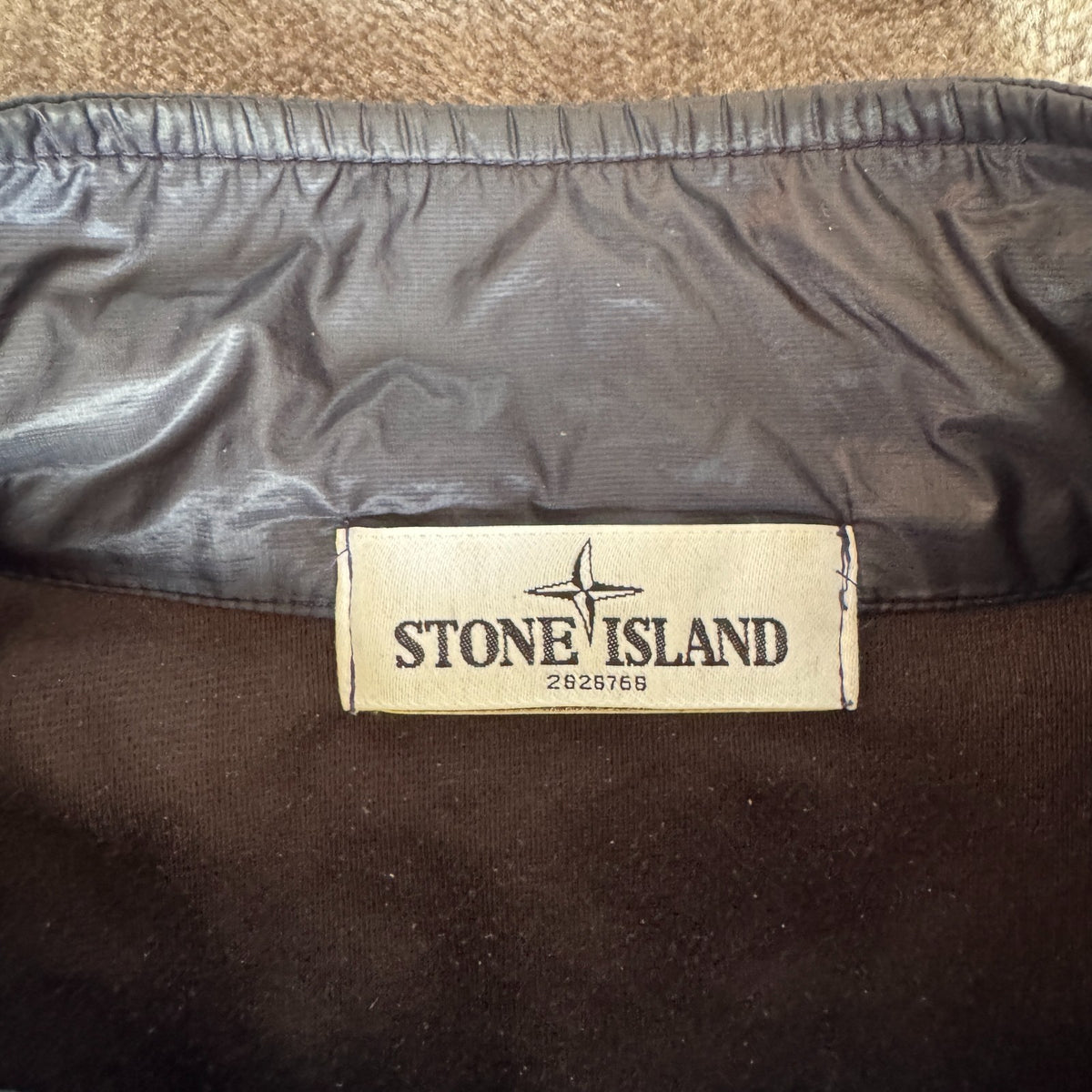 Stone Island navy quilted jacket with logo patch and micro rip stop material.