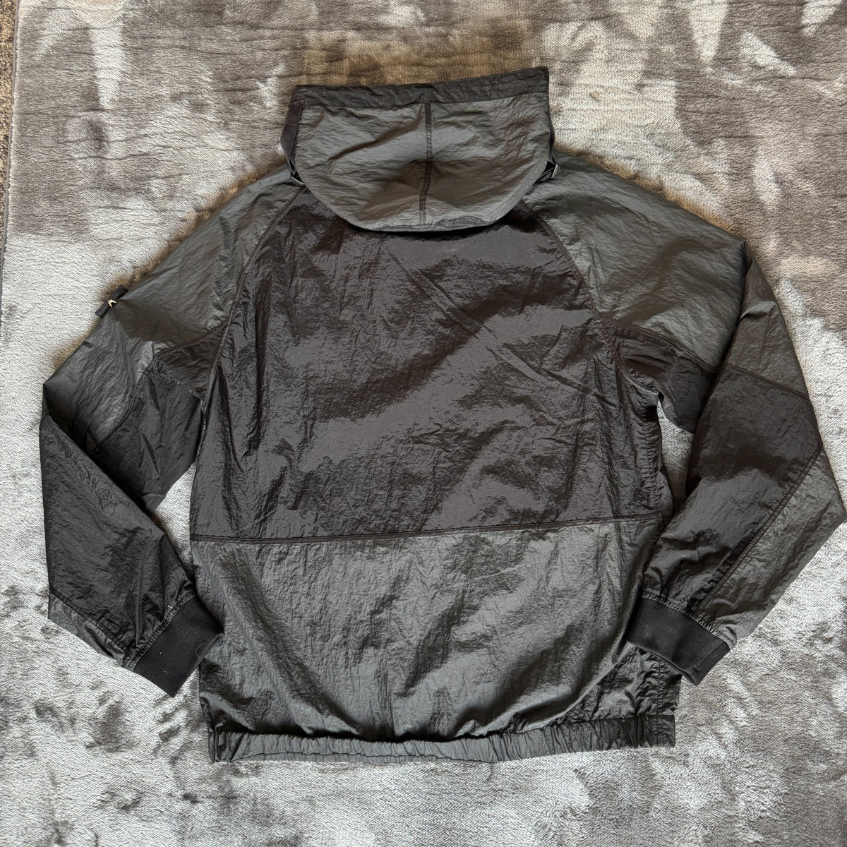 Stone Island black nylon metal Watro jacket with logo badge and visible wear marks.