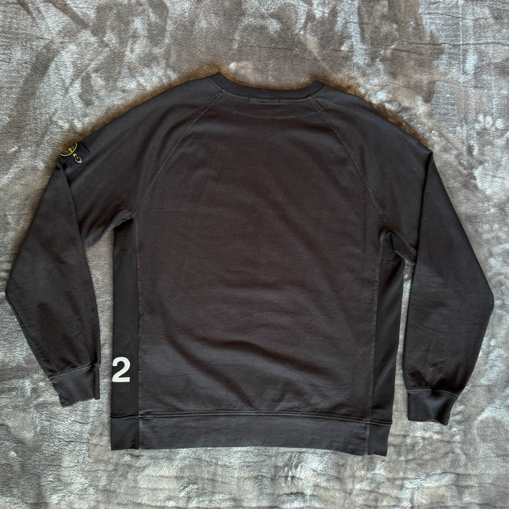 Stone Island black crewneck sweatshirt with 40th anniversary badge and logo patch.