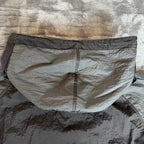 Stone Island black nylon metal Watro jacket with logo badge and visible wear marks.