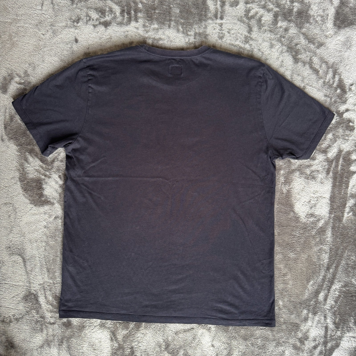 C.P. Company navy t-shirt with stamped logo and soft cotton material.
