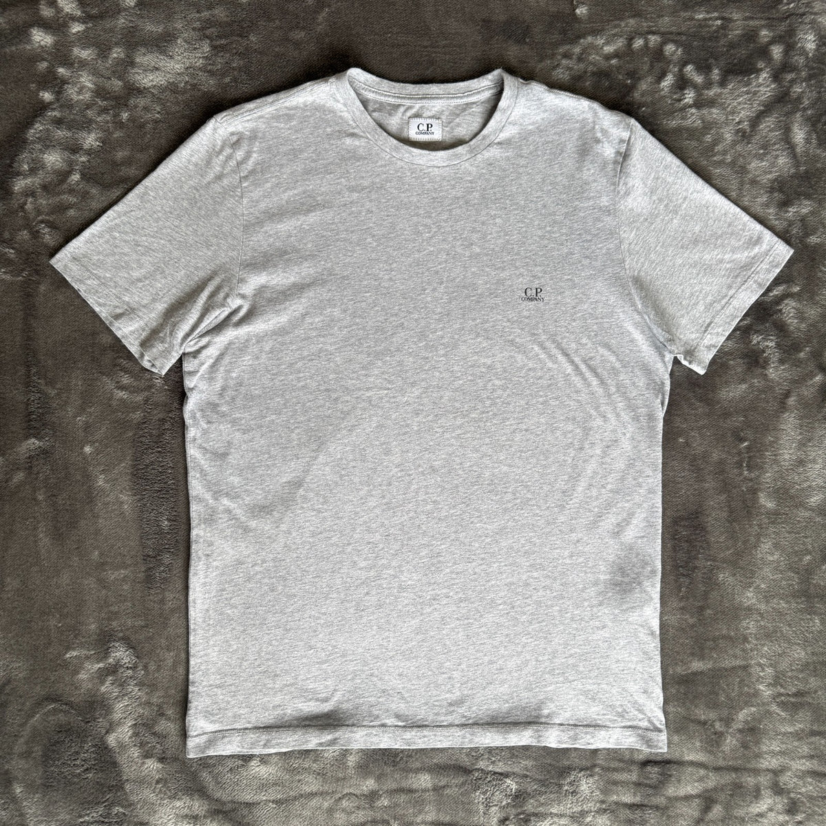 C.P. Company grey t-shirt featuring distinctive goggle print and logo detail.