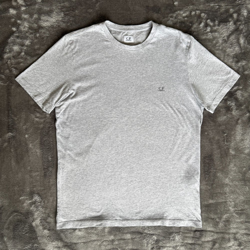 C.P. Company grey t-shirt featuring distinctive goggle print and logo detail.
