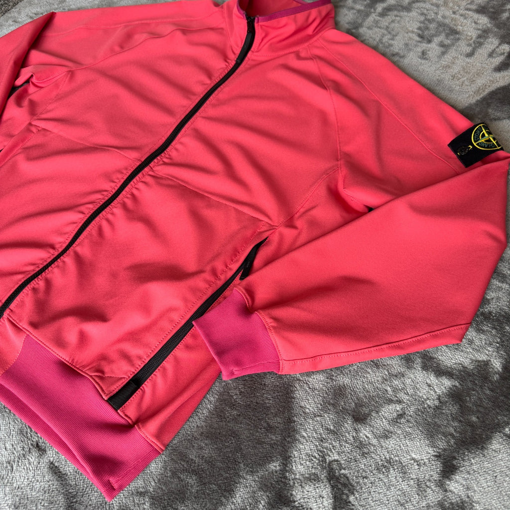 Stone Island fuchsia track jacket with logo badge and stretch nylon material.