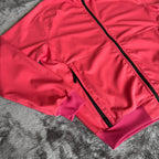 Stone Island fuchsia track jacket with logo badge and stretch nylon material.