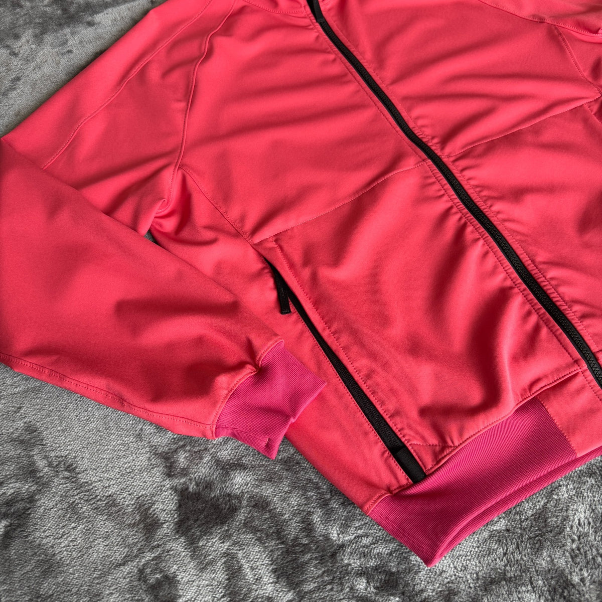 Stone Island fuchsia track jacket with logo badge and stretch nylon material.