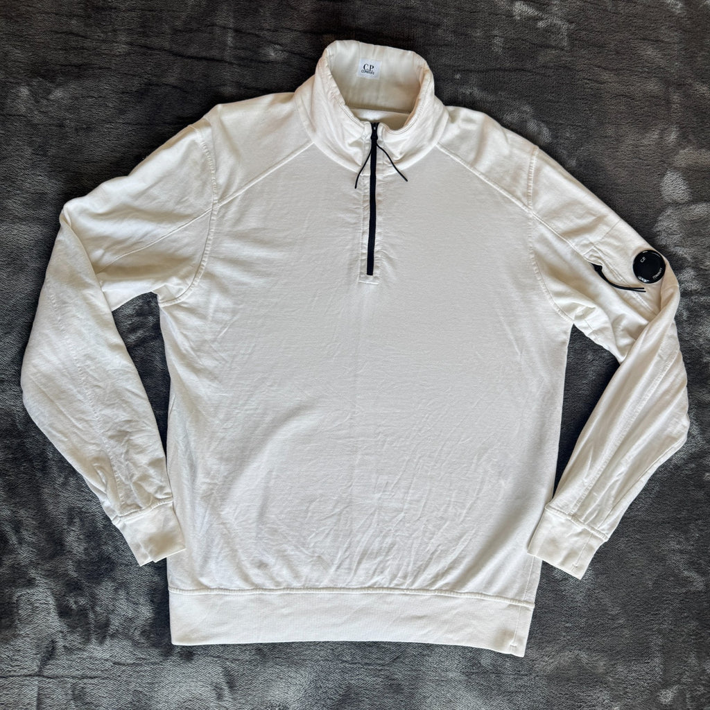 C.P. Company white quarter zip sweatshirt with logo patch and soft cotton material.