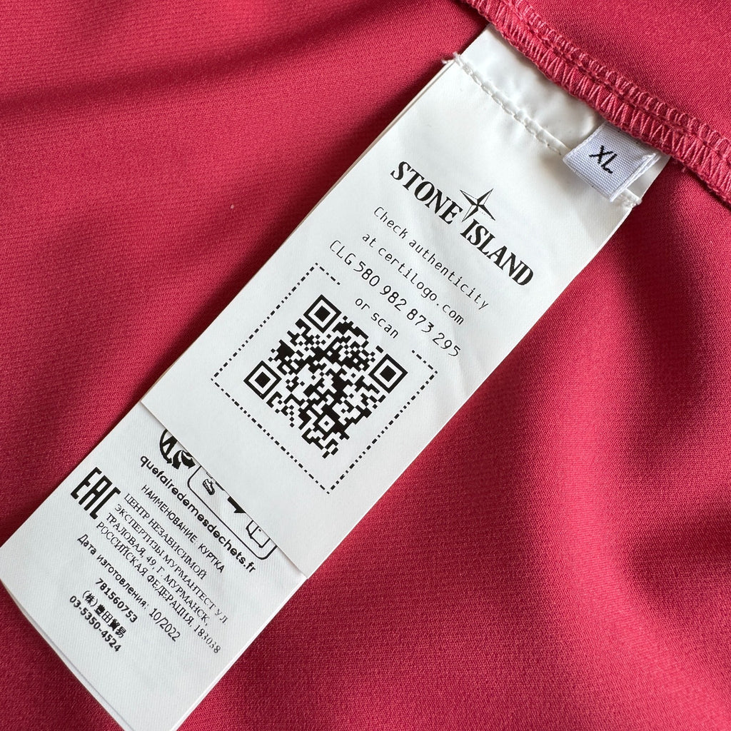 Stone Island fuchsia track jacket with logo badge and stretch nylon material.