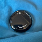 C.P. Company blue hooded smock with logo patch and Pro-Tek material details.