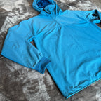 C.P. Company blue hooded smock with logo patch and Pro-Tek material details.