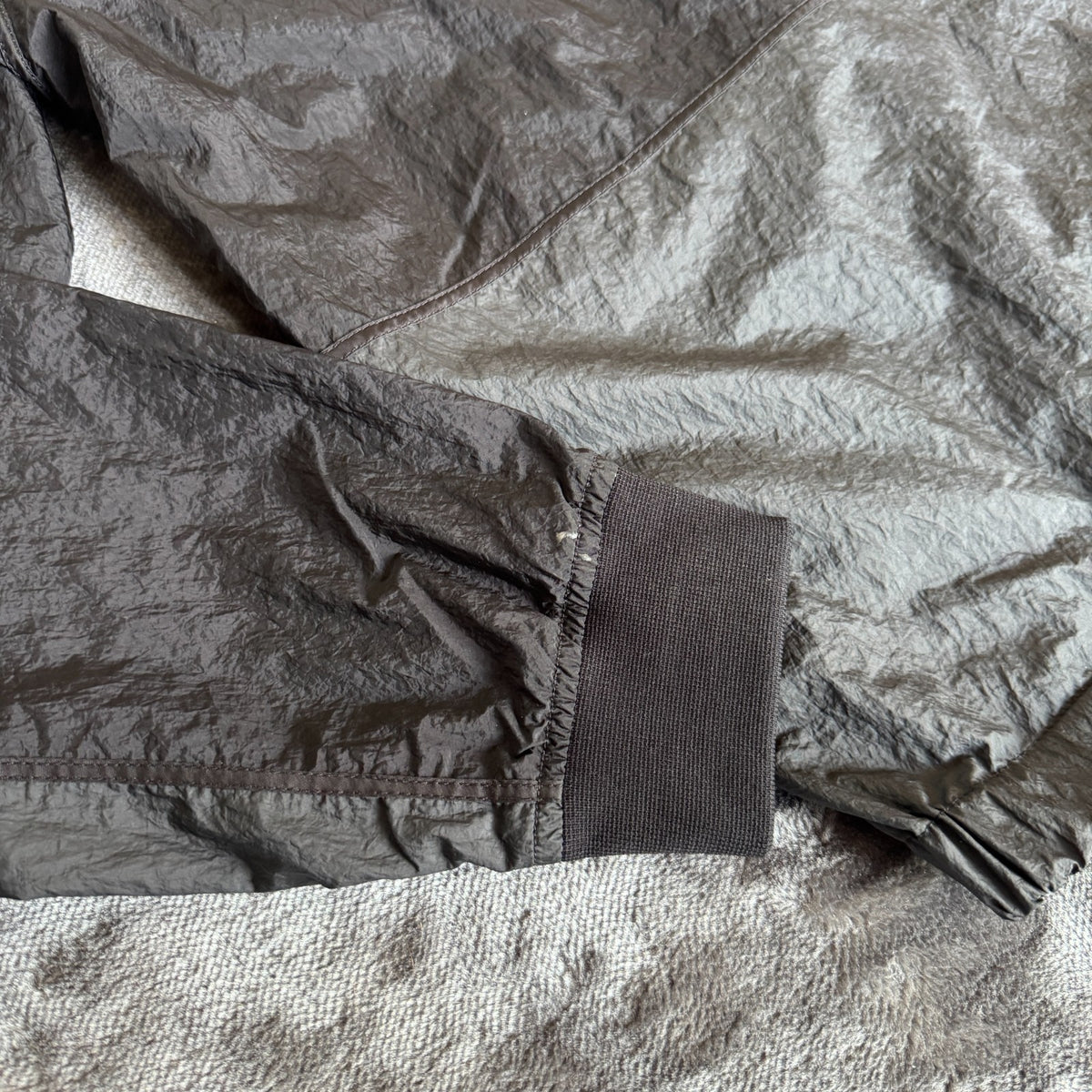 Stone Island black nylon metal Watro jacket with logo badge and visible wear marks.