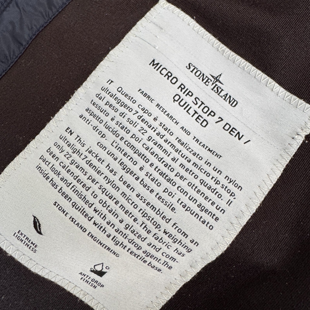 Stone Island navy quilted jacket with logo patch and micro rip stop material.